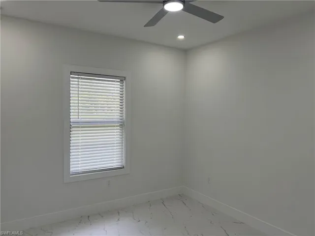 Bedroom with ceiling fan with light kit and new blinds