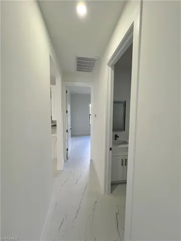 Corridor featuring baseboards