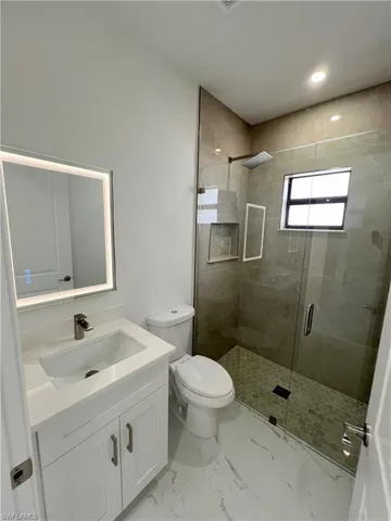 2nd Bathroom with backlit mirror and a beautiful shower