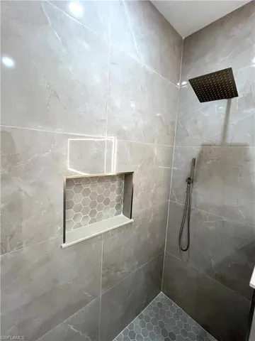 Primary Bathroom featuring tiled shower