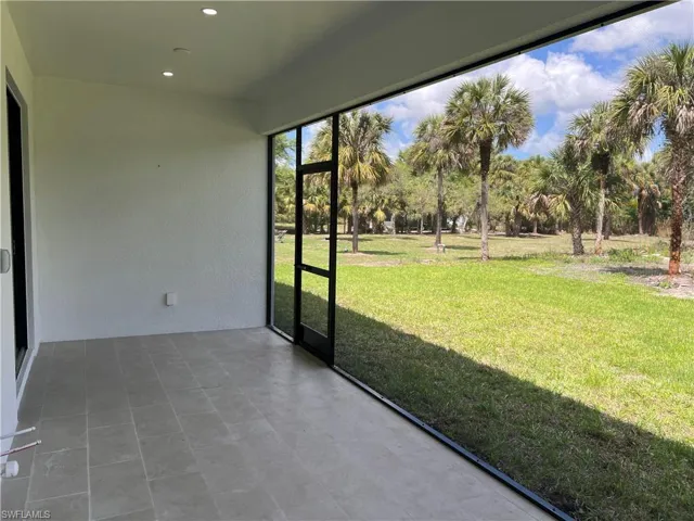 Screened lanai featuring large ceiling fans and sink