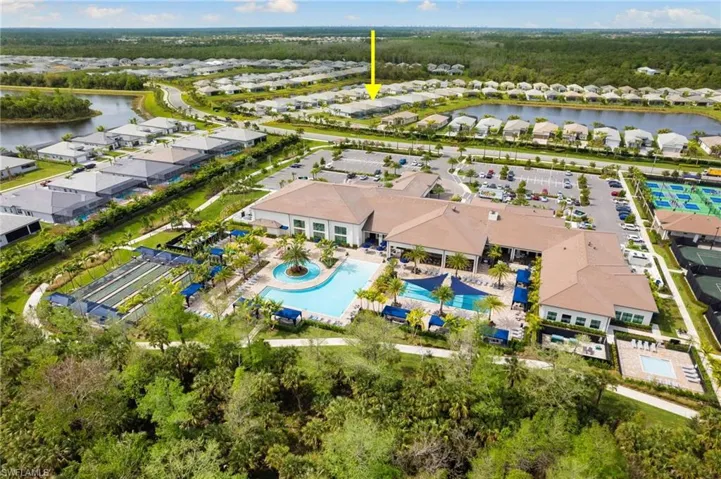 Community clubhouse featuring a large swimming pool that is located within a very short walking distance.