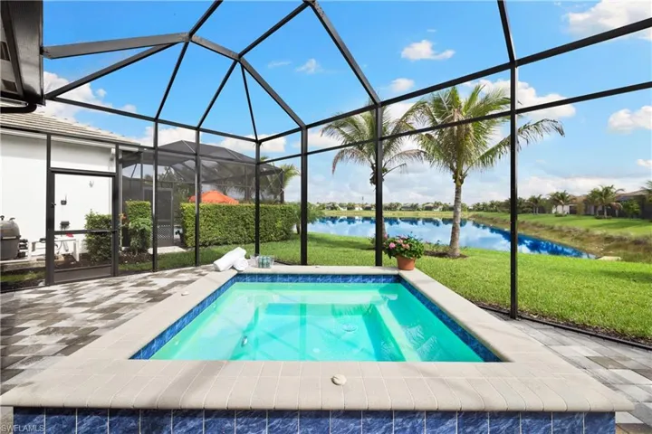 Screened lanai featuring a built-in spool with a fabulous lake view