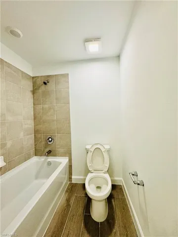 Bathroom with  shower combination and wood finish floors