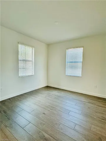 Unfurnished room with healthy amount of natural light and light wood finished floors