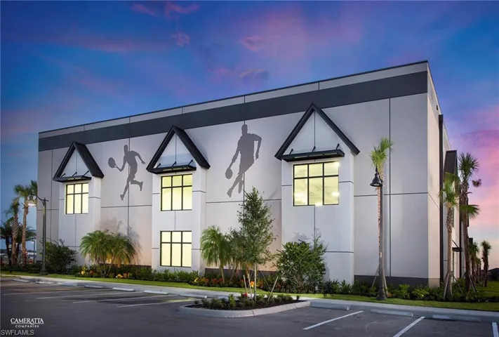 View of building exterior with uncovered parking