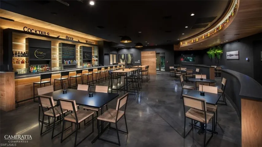 Dining space with finished concrete flooring and a community bar