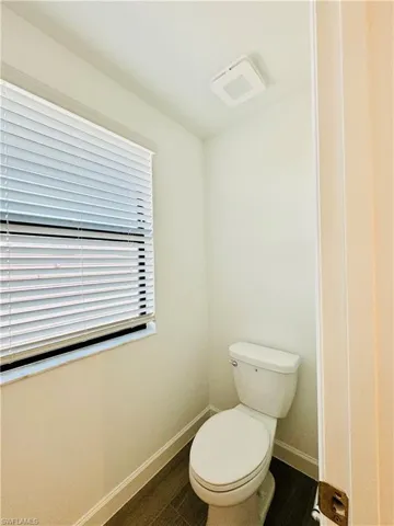 Bathroom with baseboards and dark wood finished floors