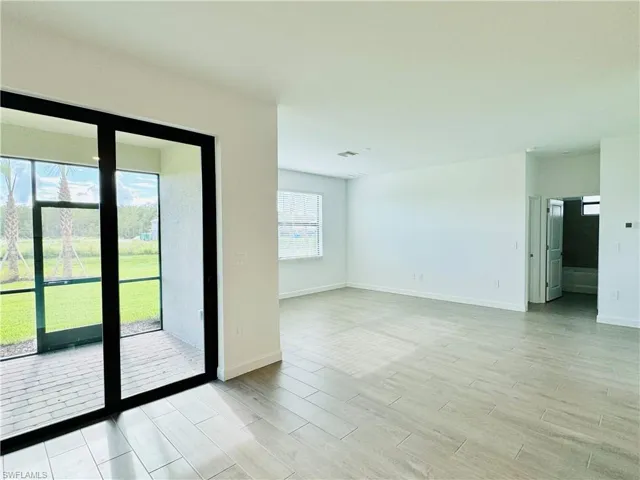 Unfurnished room featuring wood finish floors and baseboards