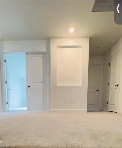 Carpeted spare room featuring recessed lighting and baseboards