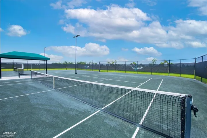 View of tennis court with community basketball court