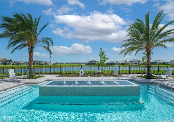 Community pool with a residential view, a patio, and a water view