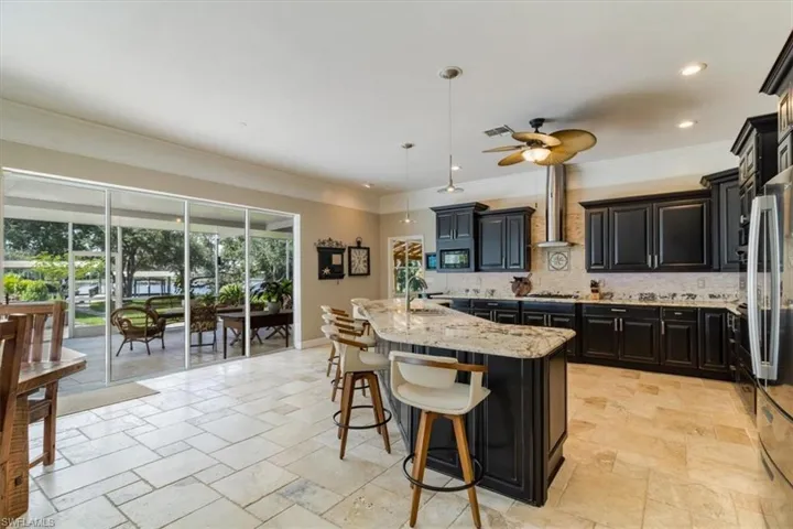 Open kitchen allows for easy access to pool area and dining room