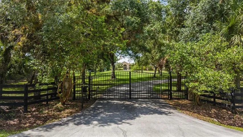 View of gate with a lawn