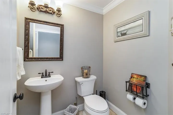 Guest Bathroom#2 featuring ornamental molding and toilet