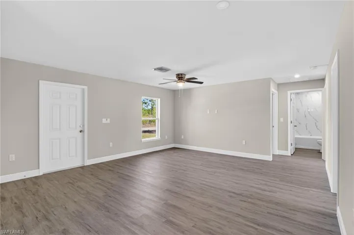 Unfurnished room featuring wood finished floors, a ceiling fan, and recessed lighting