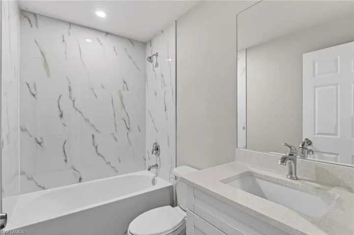 Bathroom with vanity and shower / tub combination