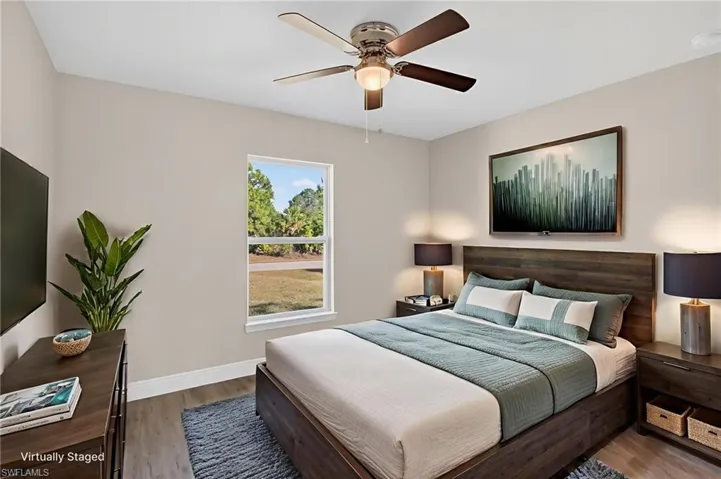 Bedroom featuring wood finished floors and ceiling fan