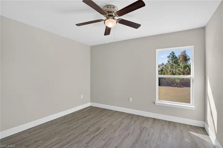 Unfurnished room featuring light wood-style floors and a ceiling fan