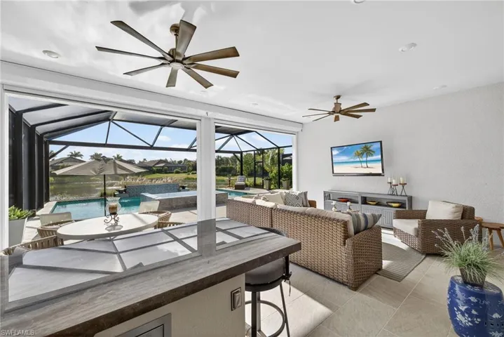Living area featuring a sunroom and a textured wall
