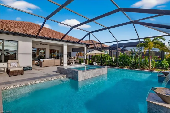 View of pool featuring an outdoor hangout area, a lanai, a sunroom, a patio area, and a pool with connected hot tub