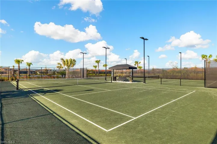 View of tennis court featuring community basketball court and a gazebo