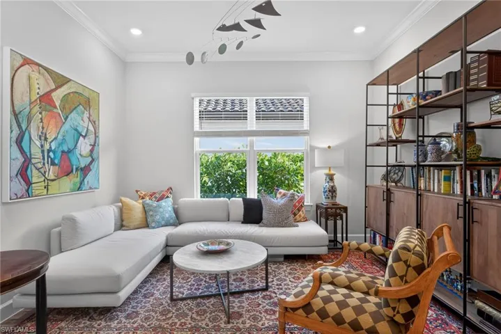 Living room with ornamental molding and recessed lighting