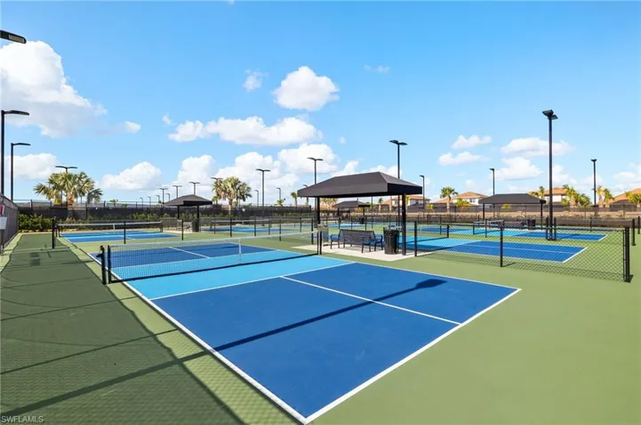 View of tennis court with a gazebo and community basketball court