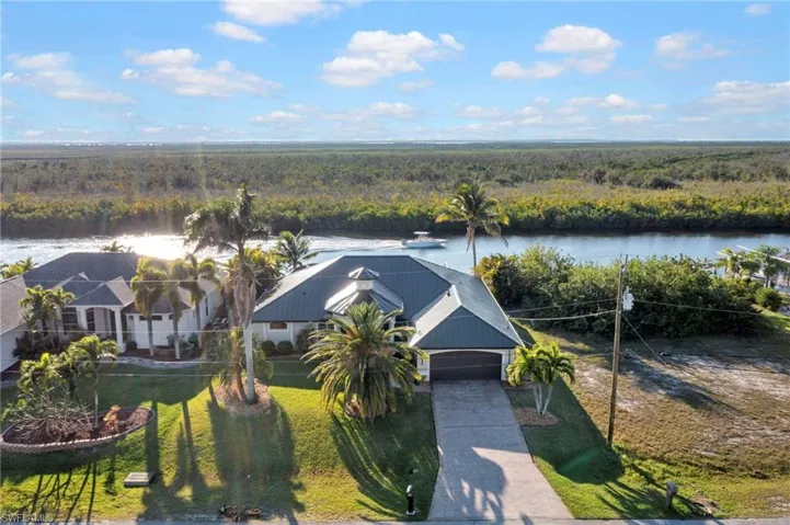 Bird's eye view featuring a water view and a wooded view