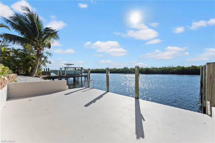 Dock area featuring a water view and boat lift