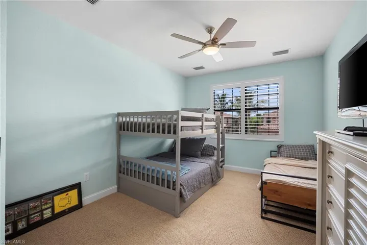 Bedroom featuring light colored carpet and ceiling fan