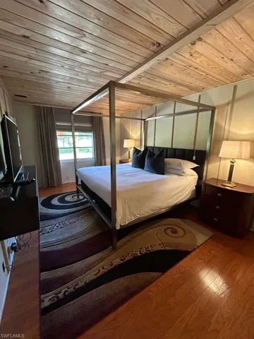 Bedroom featuring wood ceiling and wood finished floors