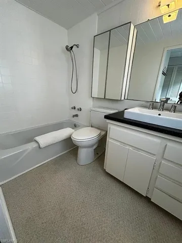 Full bath featuring vanity and shower / bath combination