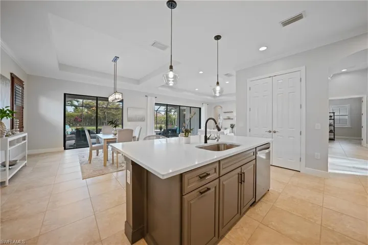Beautiful two toned kitchen island, great for family dinners of entertaining. Slick Quartz counters, integrated sink, sleek fixtures & Lighting along with under counter lighting
