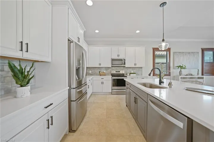 Stunning kitchen with lighted tile backsplash and stainless steel upgraded appliances