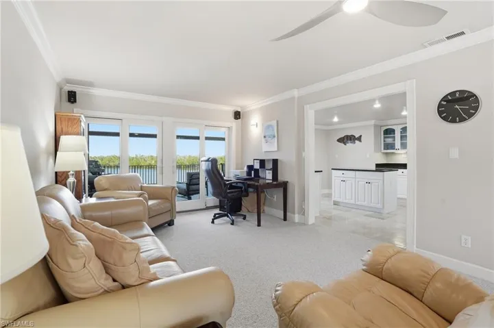 Office featuring crown molding, light colored carpet, and a ceiling fan