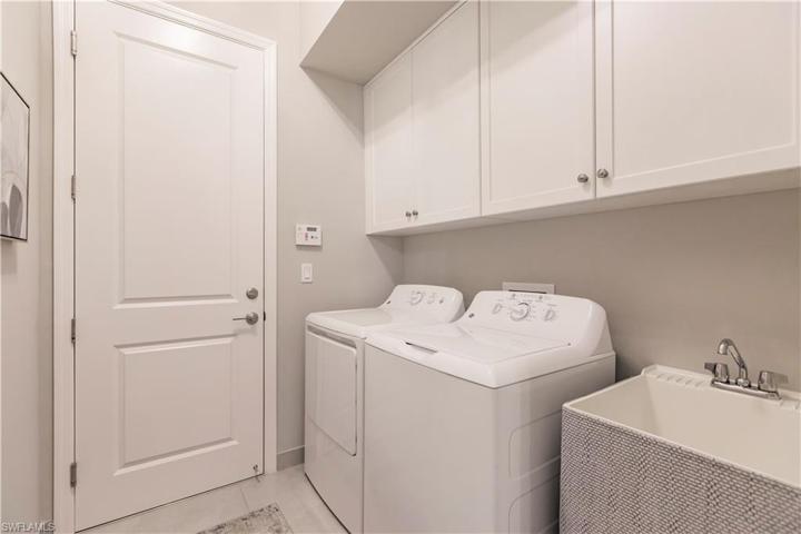 The laundry has added cabinetry and convenient utility sink.  Need to wash off those shells you discovered on the beach?  This is just perfect!
