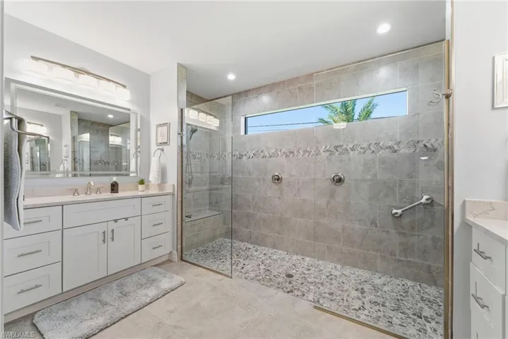Bathroom featuring vanity and a walk in shower