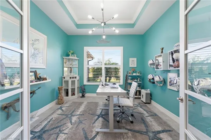 Home office featuring a chandelier and crown molding