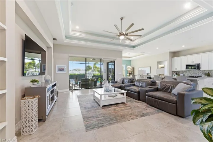 Living area with plenty of natural light, a ceiling fan, ornamental molding, and recessed lighting