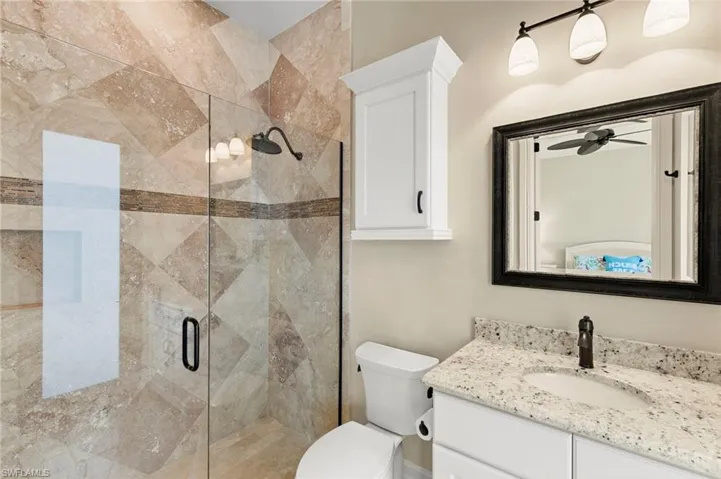 En-suite bathroom with walk-in shower, doubles as the pool bath