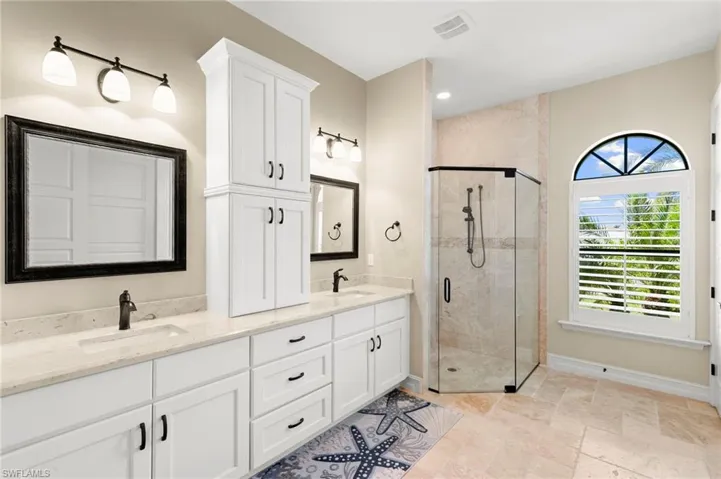 Separate sinks, plenty of cabinet space and a walk-in shower