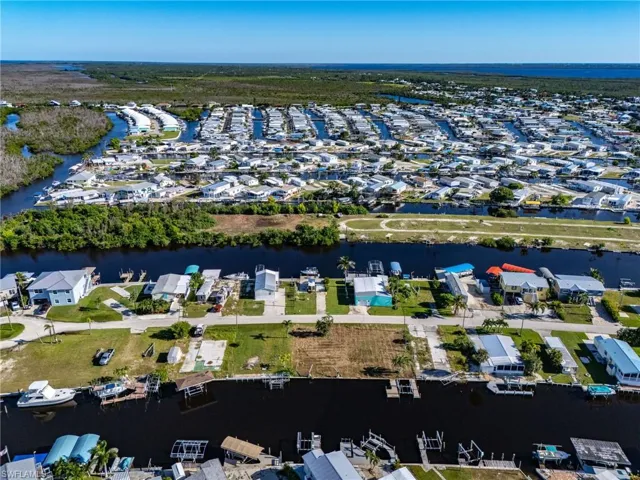View of property location with a nearby body of water and nearby suburban area
