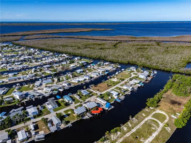 View of property location with a nearby body of water and nearby suburban area
