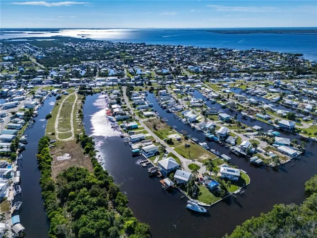 View of property location featuring a nearby body of water and nearby suburban area