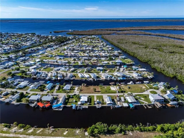 Aerial perspective of suburban area with a nearby body of water