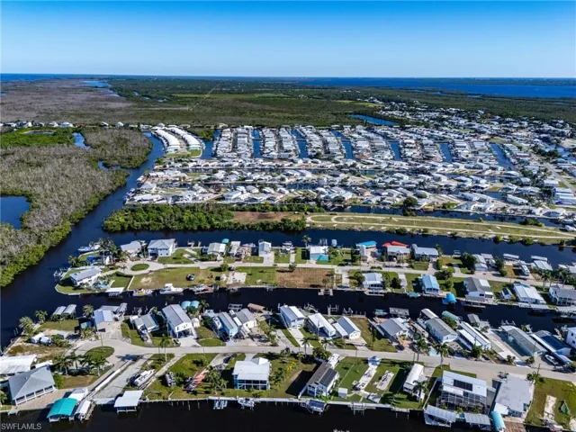 Aerial view of property's location with nearby suburban area and a nearby body of water