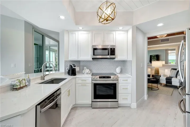 Modern white kitchen with Stainless steel appliances