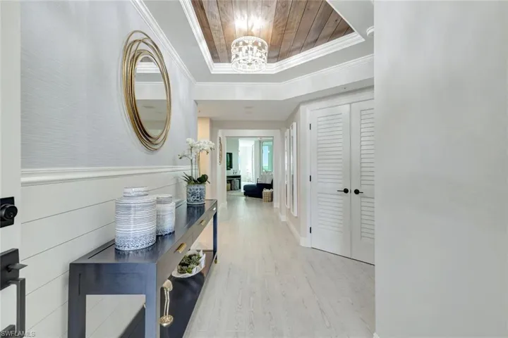 Elegant foyer with tray ceiling & shiplap wall