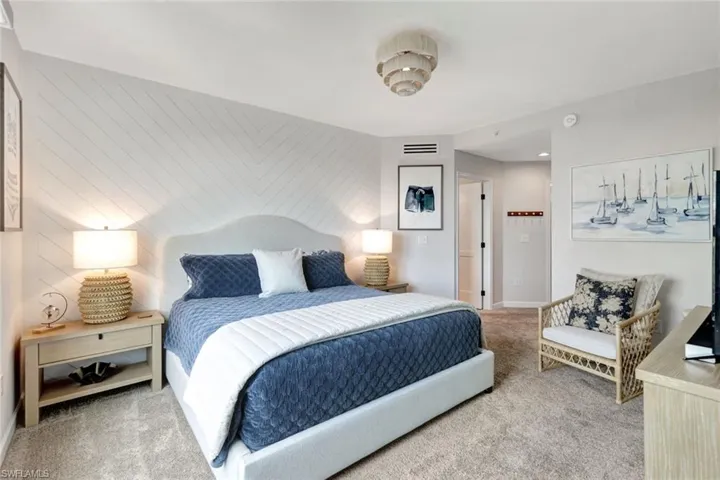 Primary bedroom suite with shiplap accent wall & plush new carpeting